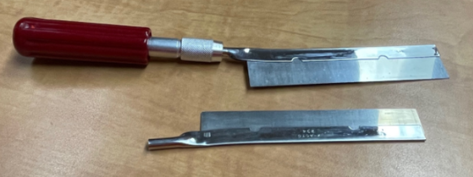 A crosscut saw which is a small hand tool with a rectangular blade.