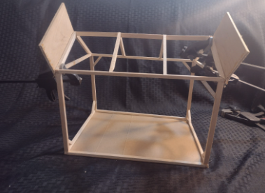 Two sheets of balsa, measuring 12” by 4” by ⅛”, are clamped to the left and right edge rafters so that they are perpendicular to the plane of the roof.