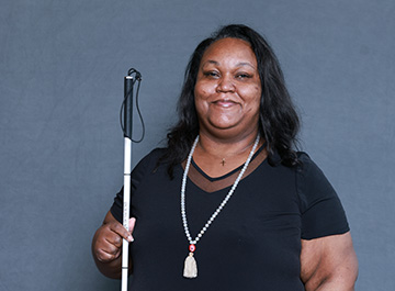 Marilyn Green stands with her cane in hand.
