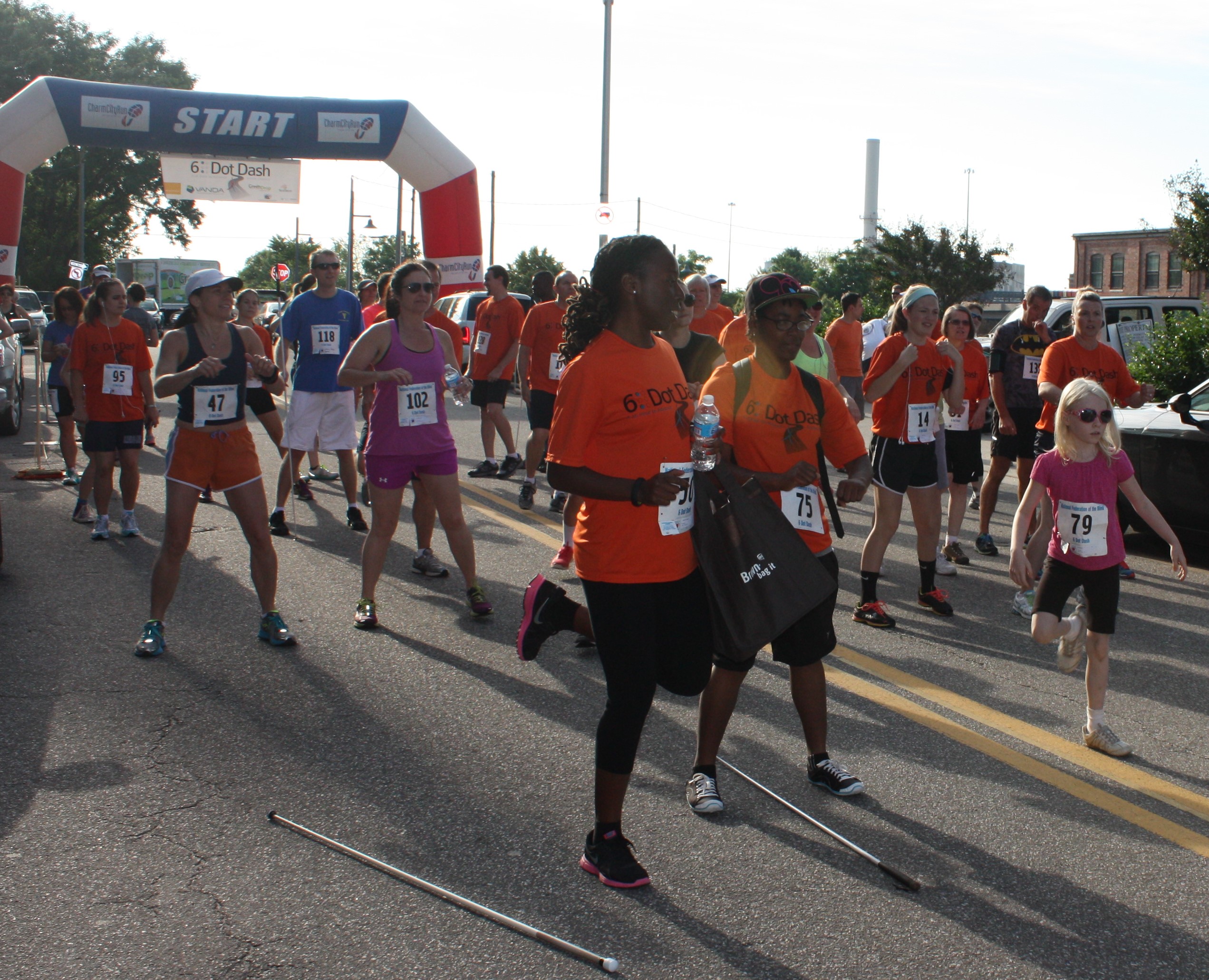 Blind and sighted runners warm up for the 6 Dot Dash
