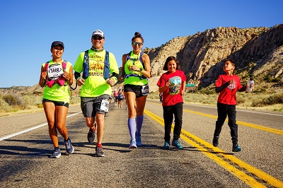 Terri Rupp runs alongside her guides and her two children.