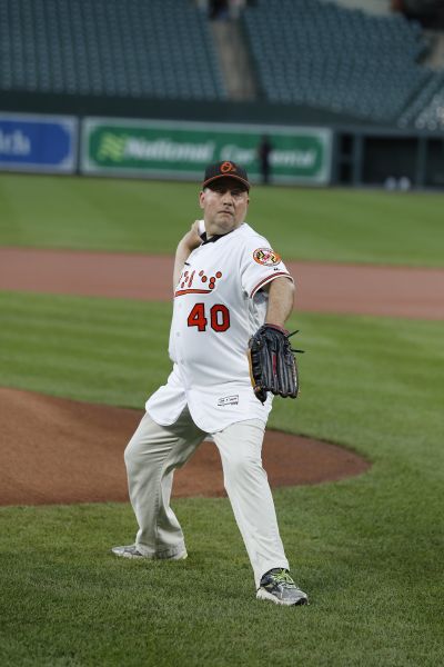 NFB President Mark A. Riccobono wears an Oriole jersey with Braille on it, and stands on the mound at Oriole Park at Camden Yards as he throws the first pitch.