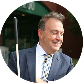 Mark Riccobono smiles casually while looking off to the side.