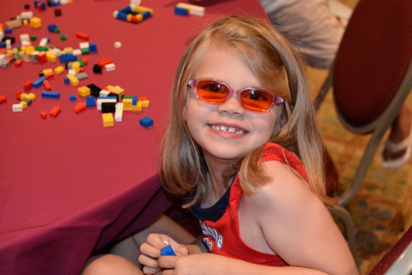 A young girl smiles at our national convention.