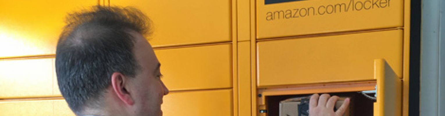 Mark Riccobono opens a box to retrieve his package from an Amazon Locker.