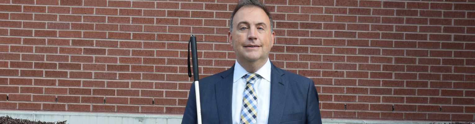 Mark Riccobono stands in front of the entrance to the Jernigan Institute.
