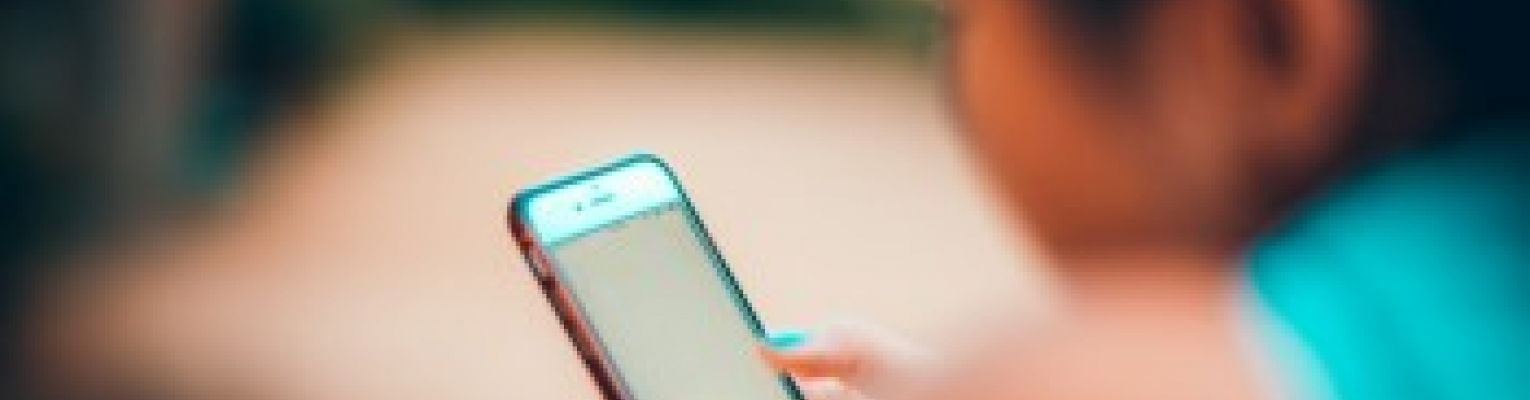 A woman uses her smart phone.
