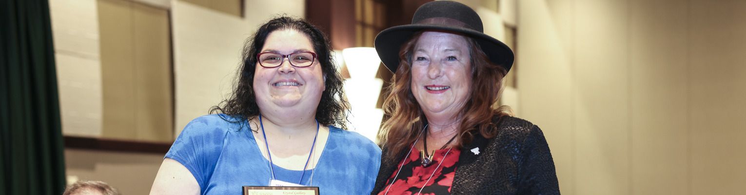 Krystal Guillory smiles with Carla McQuillan who just presented her with the Educator of Blind Students Award.