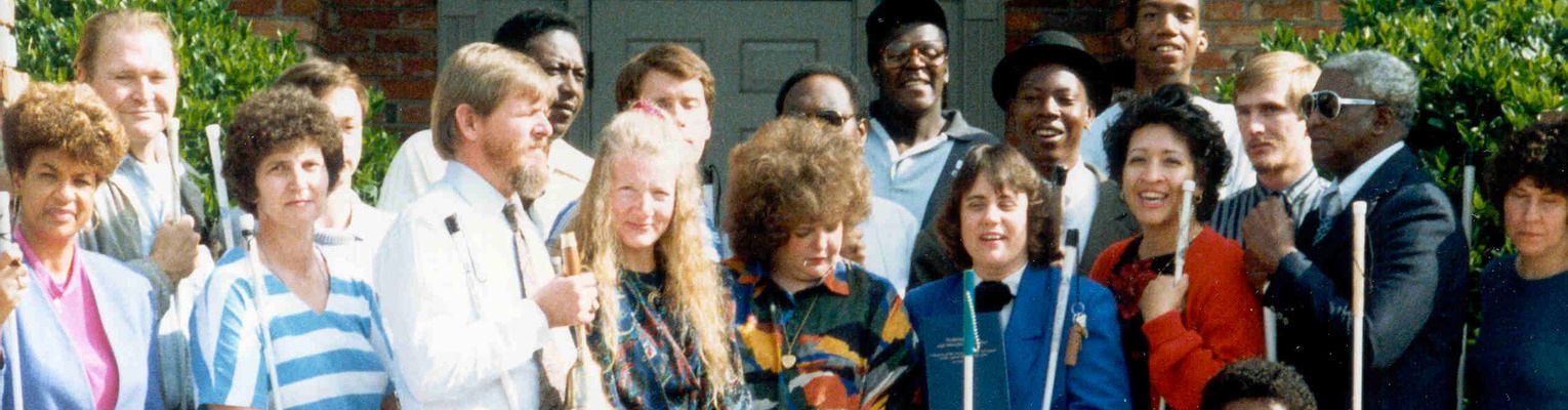 Joanne poses with staff and students of the Louisiana Center for the Blind at the center's 50th Anniversary Celebration.