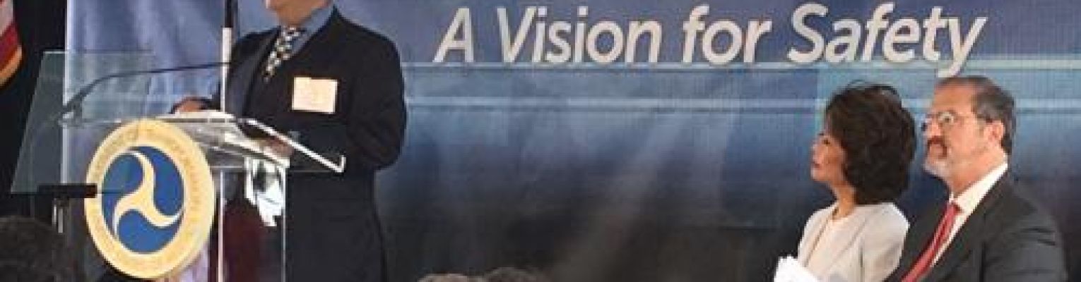 President Mark Riccobono stands at a podium to address the crowd at USDOT's Vision for Safety event.