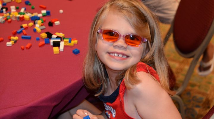 A young girl smiles at our national convention.