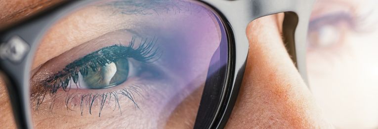 Close-up of a woman wearing glasses.
